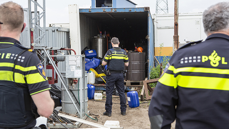 Three police officers at a drug lab